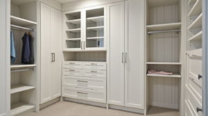 Built-in closet cabinets in Massachusetts with custom drawers, shelves, and soft-close doors in a modern bedroom.