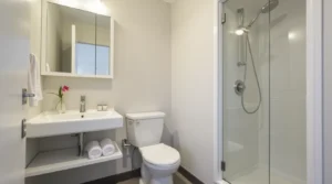 Modern small bathroom cabinet ideas with floating vanity, tall storage, and recessed mirror for space-saving design.